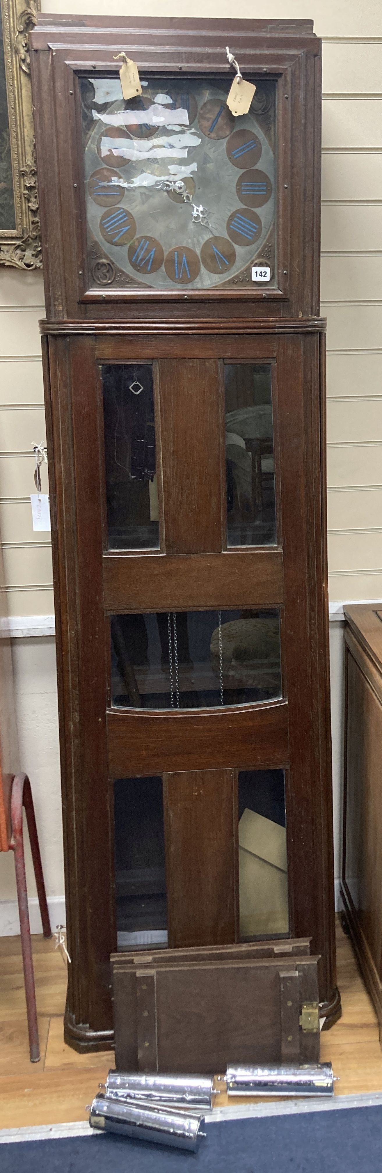 A large and unusual 20th century oak cased longcase clock, in the arts and crafts style, after Mackintosh, the 13 engraved dial with c
